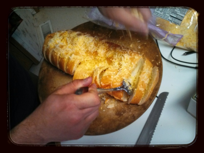 Adding Cheese to Cheesy Garlic Bread